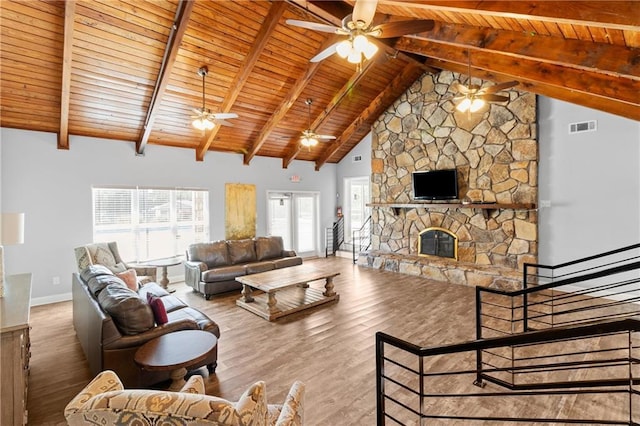 living area with visible vents, wood ceiling, ceiling fan, and wood finished floors