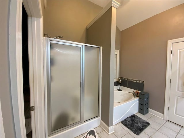 1162 Mason Lee, Loganville, GA 30052 - full bath featuring a bath, a stall shower, vaulted ceiling, baseboards, and tile patterned flooring