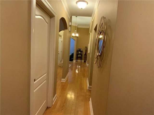 1162 Mason Lee, Loganville, GA 30052 - hall with light wood-style flooring, arched walkways, and ornamental molding