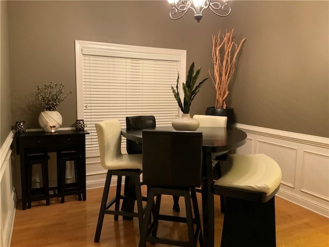 1162 Mason Lee, Loganville, GA 30052 - dining area with wainscoting, light wood-style floors, a chandelier, and a decorative wall