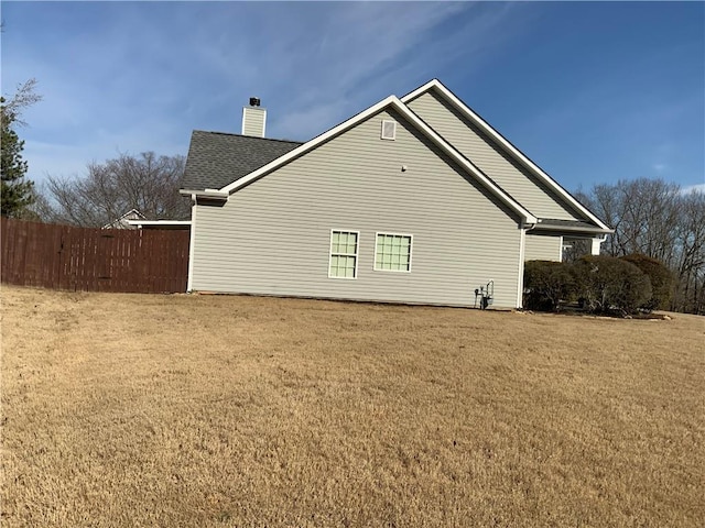 1162 Mason Lee, Loganville, GA 30052 - view of home's exterior with fence, a lawn, and a chimney