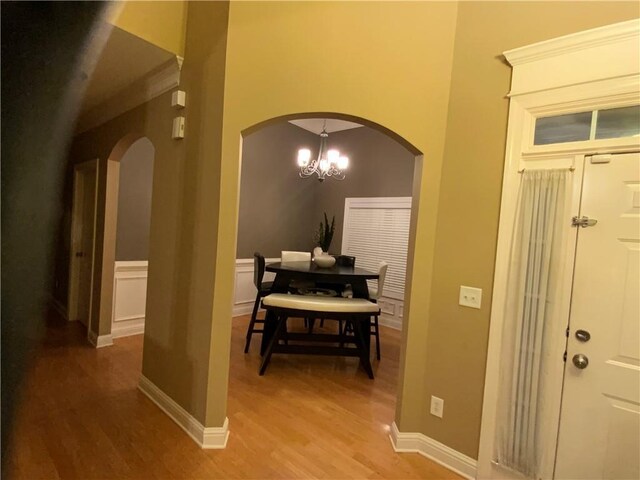1162 Mason Lee, Loganville, GA 30052 - entryway featuring arched walkways, light wood finished floors, baseboards, and a notable chandelier