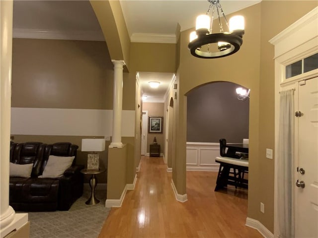 1162 Mason Lee, Loganville, GA 30052 - entrance foyer featuring crown molding, wood finished floors, a chandelier, arched walkways, and ornate columns