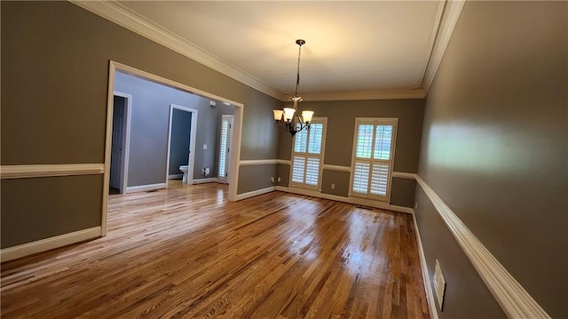 unfurnished dining area featuring ornamental molding, a notable chandelier, and light hardwood / wood-style flooring