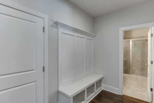 mudroom featuring dark wood-style floors and baseboards