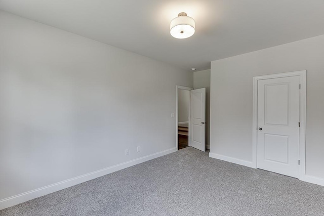 unfurnished bedroom with carpet flooring and baseboards