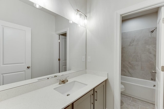 bathroom featuring toilet, shower / bathtub combination, tile patterned flooring, and vanity