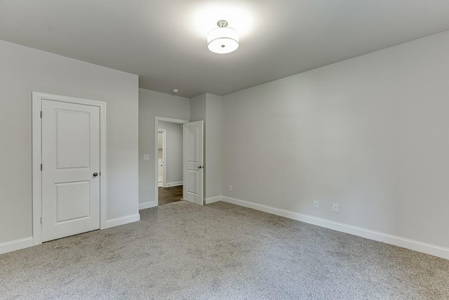 unfurnished bedroom with baseboards and light colored carpet