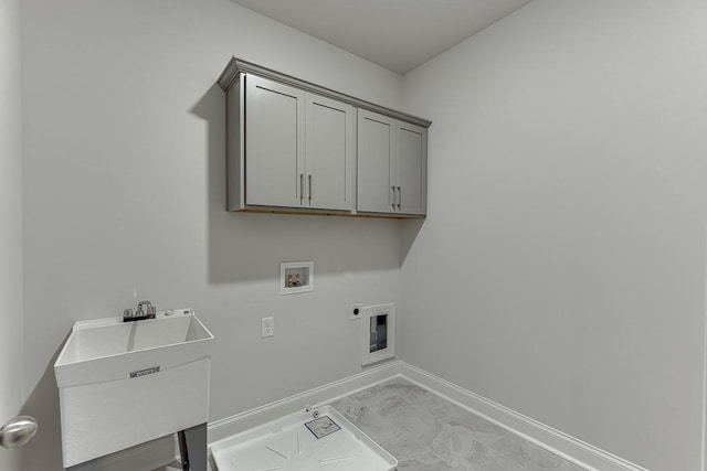 clothes washing area featuring cabinet space, baseboards, hookup for a washing machine, hookup for an electric dryer, and a sink