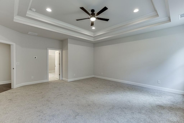 unfurnished room with carpet flooring, a raised ceiling, and visible vents