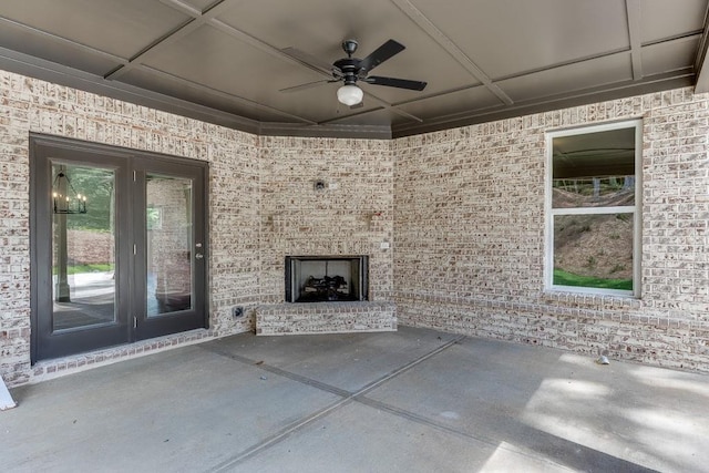 view of patio featuring an outdoor brick fireplace and ceiling fan