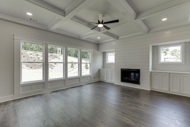 unfurnished living room featuring a fireplace, beam ceiling, coffered ceiling, and dark wood finished floors