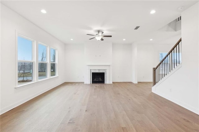 unfurnished living room featuring a fireplace, recessed lighting, light wood-style flooring, ceiling fan, and baseboards