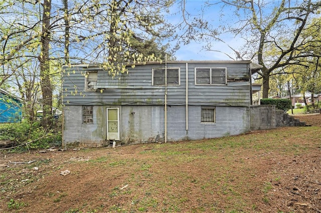 rear view of property with a lawn