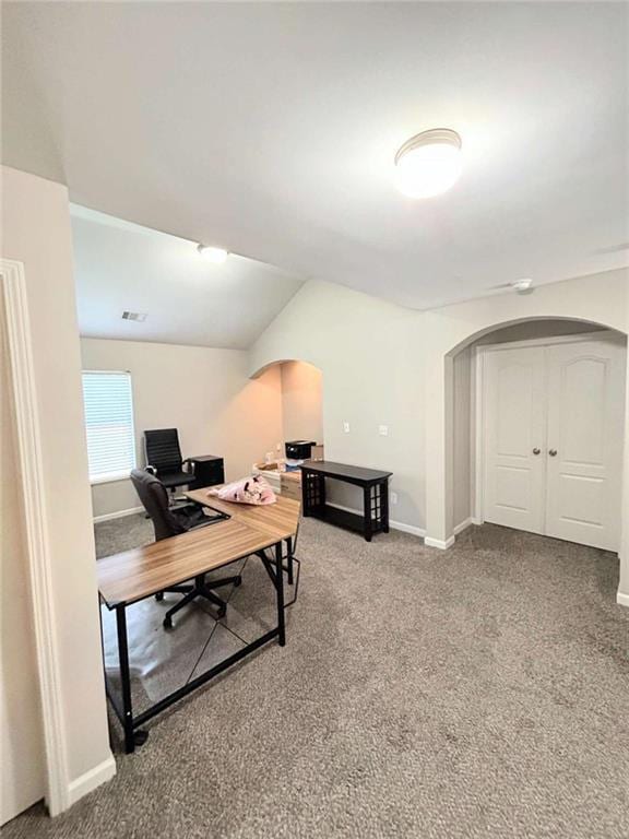 office area with baseboards, arched walkways, lofted ceiling, and carpet floors