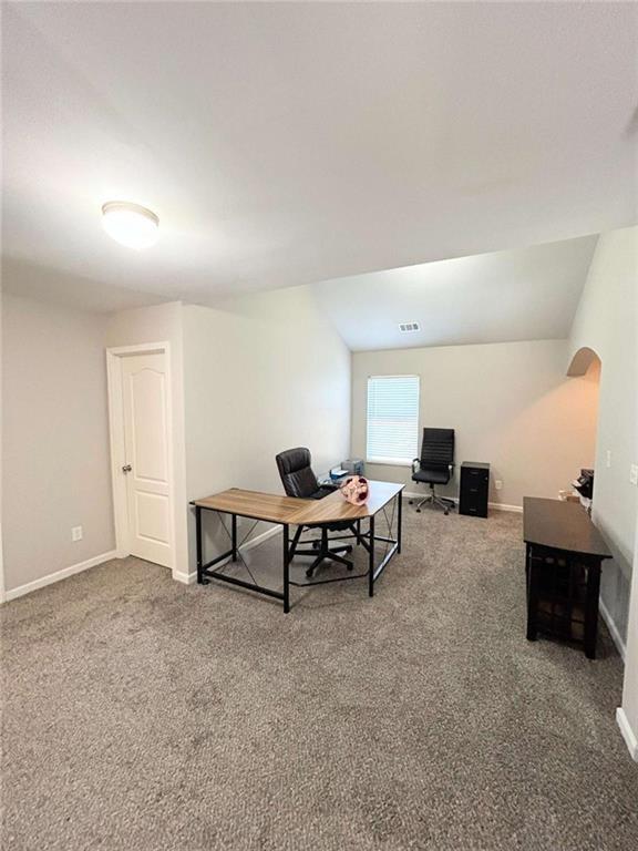 home office featuring baseboards, carpet floors, and visible vents