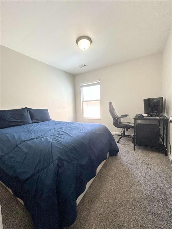 carpeted bedroom featuring visible vents