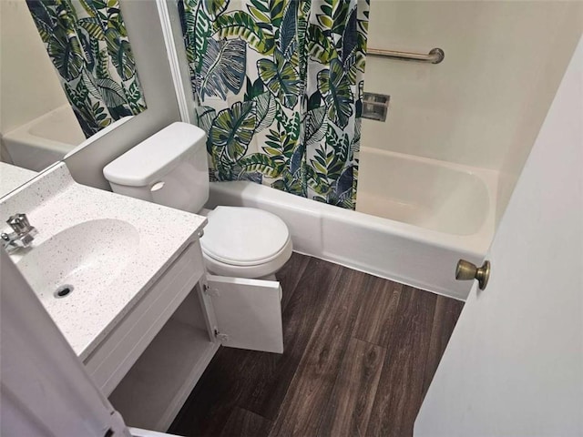 full bathroom with vanity, hardwood / wood-style floors, shower / bath combo, and toilet