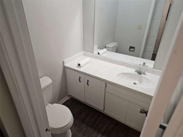 bathroom with vanity, wood-type flooring, and toilet