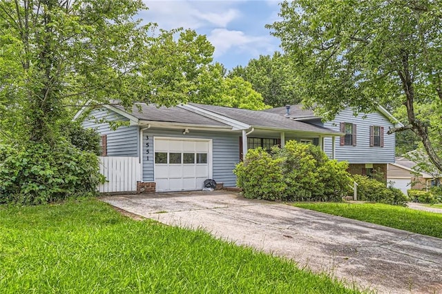 3551 Cindy Way, Rex, GA 30273 - split level home featuring an attached garage, concrete driveway, a front yard, and roof with shingles