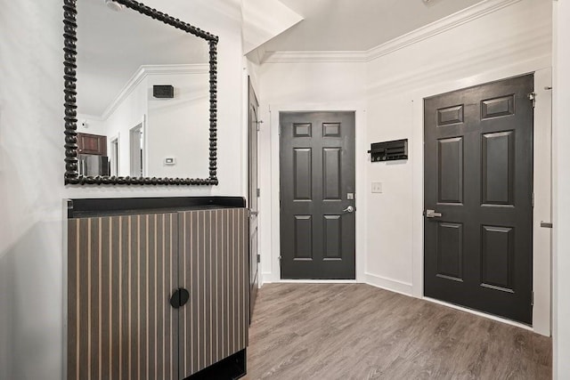 foyer featuring ornamental molding and hardwood / wood-style floors