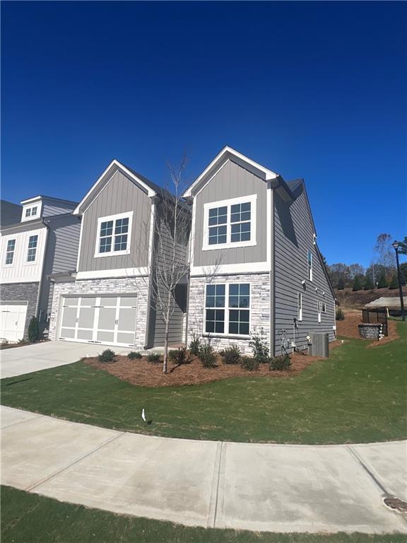 view of front facade featuring a garage and a front lawn