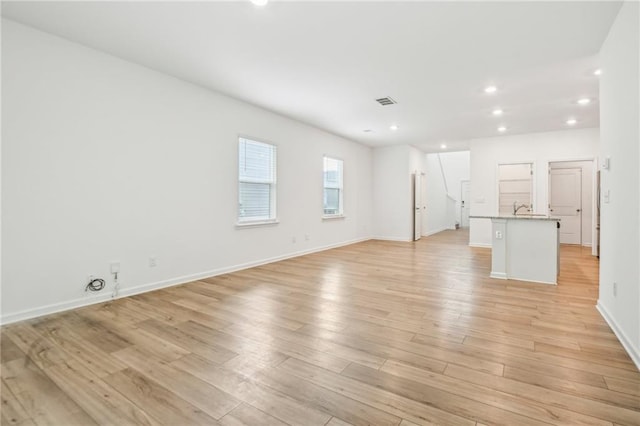 unfurnished living room featuring light hardwood / wood-style floors