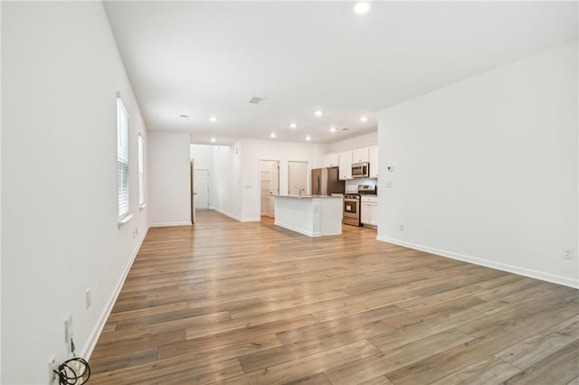 unfurnished living room featuring light hardwood / wood-style floors