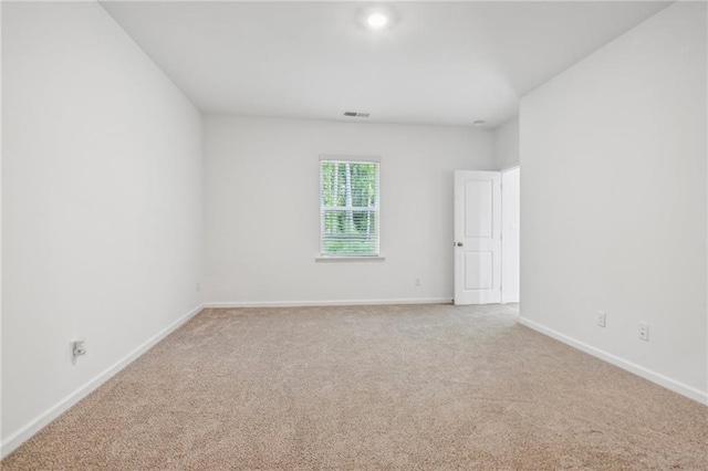 spare room with light colored carpet