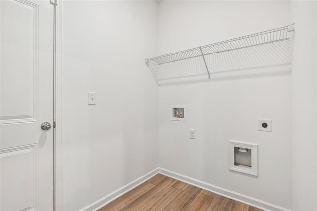 clothes washing area featuring washer hookup, hardwood / wood-style flooring, and electric dryer hookup