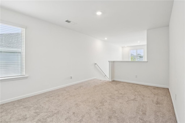 empty room featuring light carpet and plenty of natural light