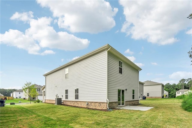 view of side of home featuring a lawn, a patio area, and central AC