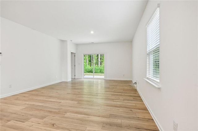 empty room with light hardwood / wood-style floors