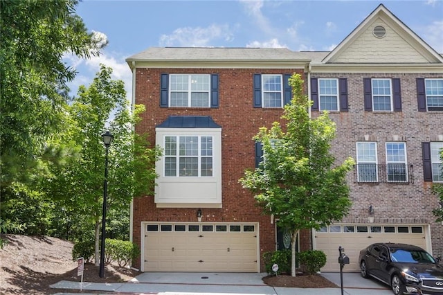 5060 Windcrest Ln, Alpharetta, GA 30022 - townhome / multi-family property with a garage, brick siding, and driveway