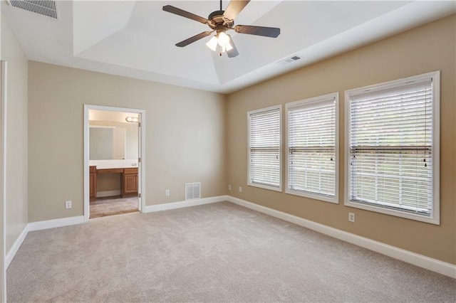 5060 Windcrest Ln, Alpharetta, GA 30022 - unfurnished bedroom featuring a tray ceiling, light carpet, ensuite bath, and ceiling fan
