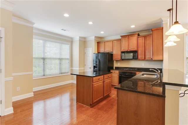 5060 Windcrest Ln, Alpharetta, GA 30022 - kitchen with black appliances, a center island, light wood-style floors, brown cabinets, and ornamental molding