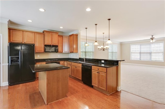 5060 Windcrest Ln, Alpharetta, GA 30022 - kitchen with black appliances, a peninsula, ornamental molding, dark stone countertops, and a center island