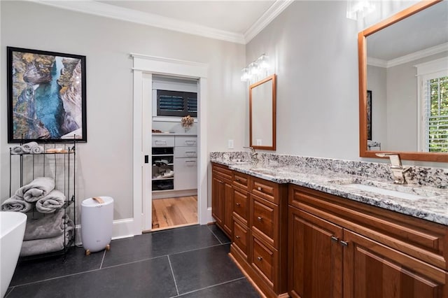 bathroom with ornamental molding, tile patterned flooring, vanity, and a bathtub