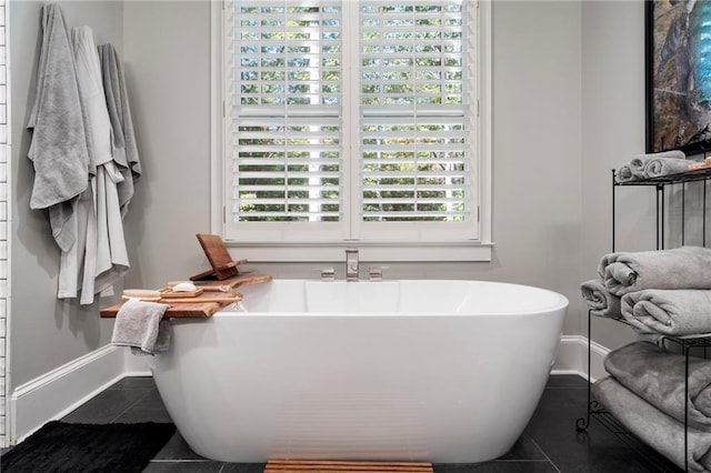 bathroom featuring tile patterned flooring and a bath