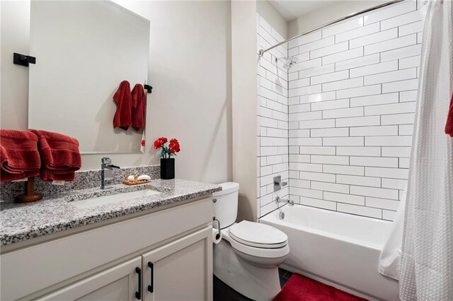 full bathroom with shower / bath combo, vanity, and toilet