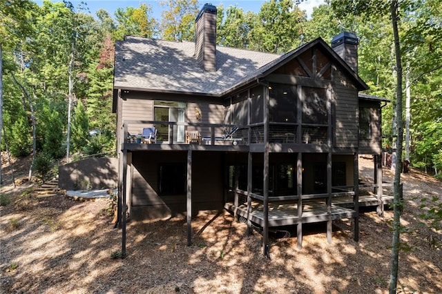 rear view of house featuring a deck