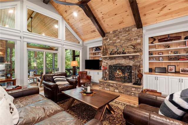 living room with beamed ceiling, wood-type flooring, wood ceiling, a stone fireplace, and high vaulted ceiling