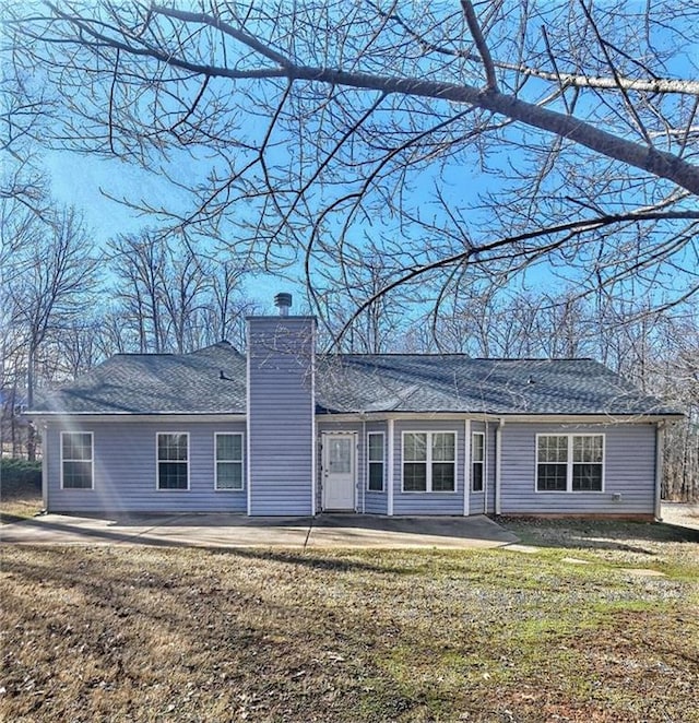 rear view of house with a yard and a patio