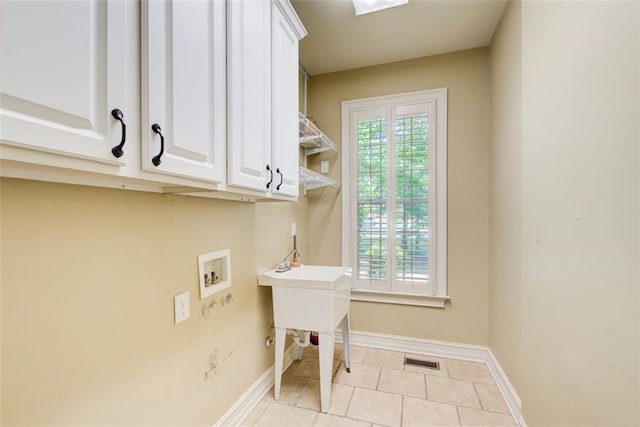245 Ashley Forest Dr, Fayetteville, GA 30214 - laundry room with washer hookup, baseboards, light tile patterned flooring, and cabinet space
