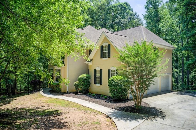 245 Ashley Forest Dr, Fayetteville, GA 30214 - view of front facade with a garage, concrete driveway, stucco siding, and a shingled roof