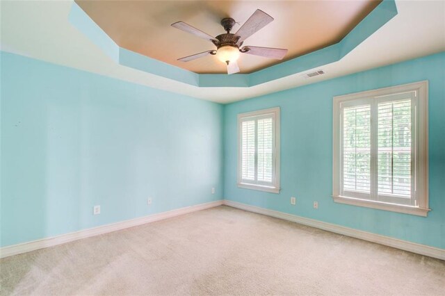 245 Ashley Forest Dr, Fayetteville, GA 30214 - empty room featuring a ceiling fan, a raised ceiling, ornamental molding, carpet floors, and arched walkways
