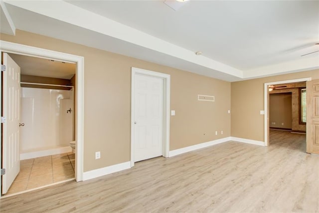 245 Ashley Forest Dr, Fayetteville, GA 30214 - unfurnished bedroom featuring light wood finished floors, baseboards, and connected bathroom