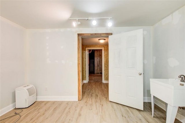 245 Ashley Forest Dr, Fayetteville, GA 30214 - unfurnished room featuring rail lighting, light wood-style flooring, and baseboards