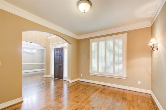 245 Ashley Forest Dr, Fayetteville, GA 30214 - unfurnished room with arched walkways, wood finished floors, ornamental molding, baseboards, and a chandelier