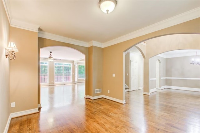 245 Ashley Forest Dr, Fayetteville, GA 30214 - spare room featuring ceiling fan, arched walkways, light wood finished floors, crown molding, and baseboards